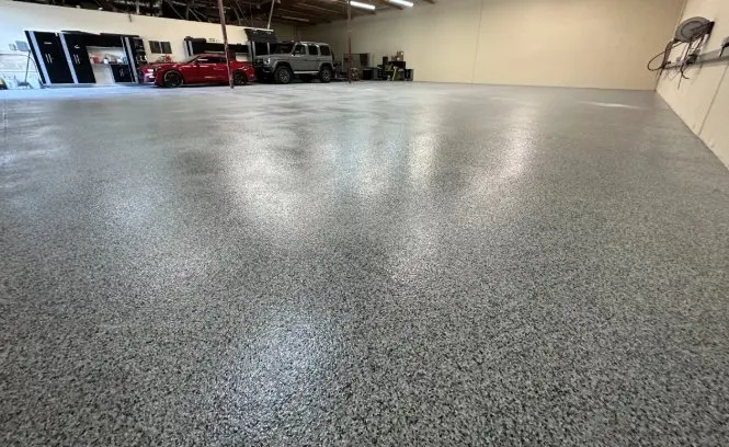 Commercial shop floor with epoxy flake coating and vehicles