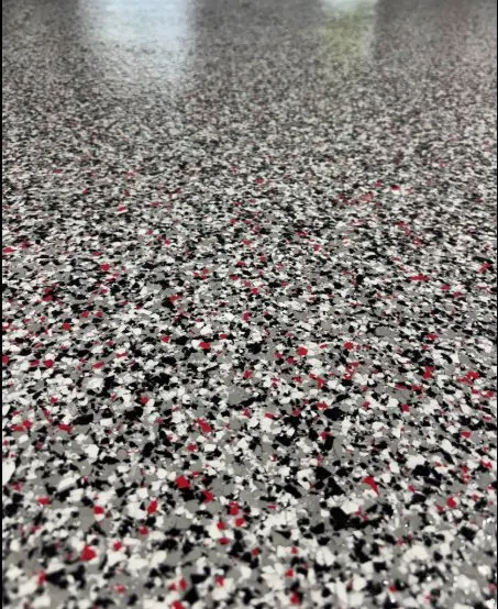 Close-up of red black and white epoxy flake floor texture