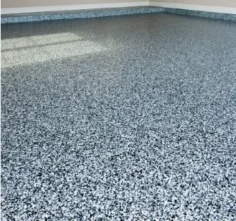 Blue gray epoxy flake floor meeting garage wall edge