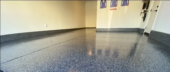 Dark flake epoxy garage floor coating with glossy polyaspartic topcoat